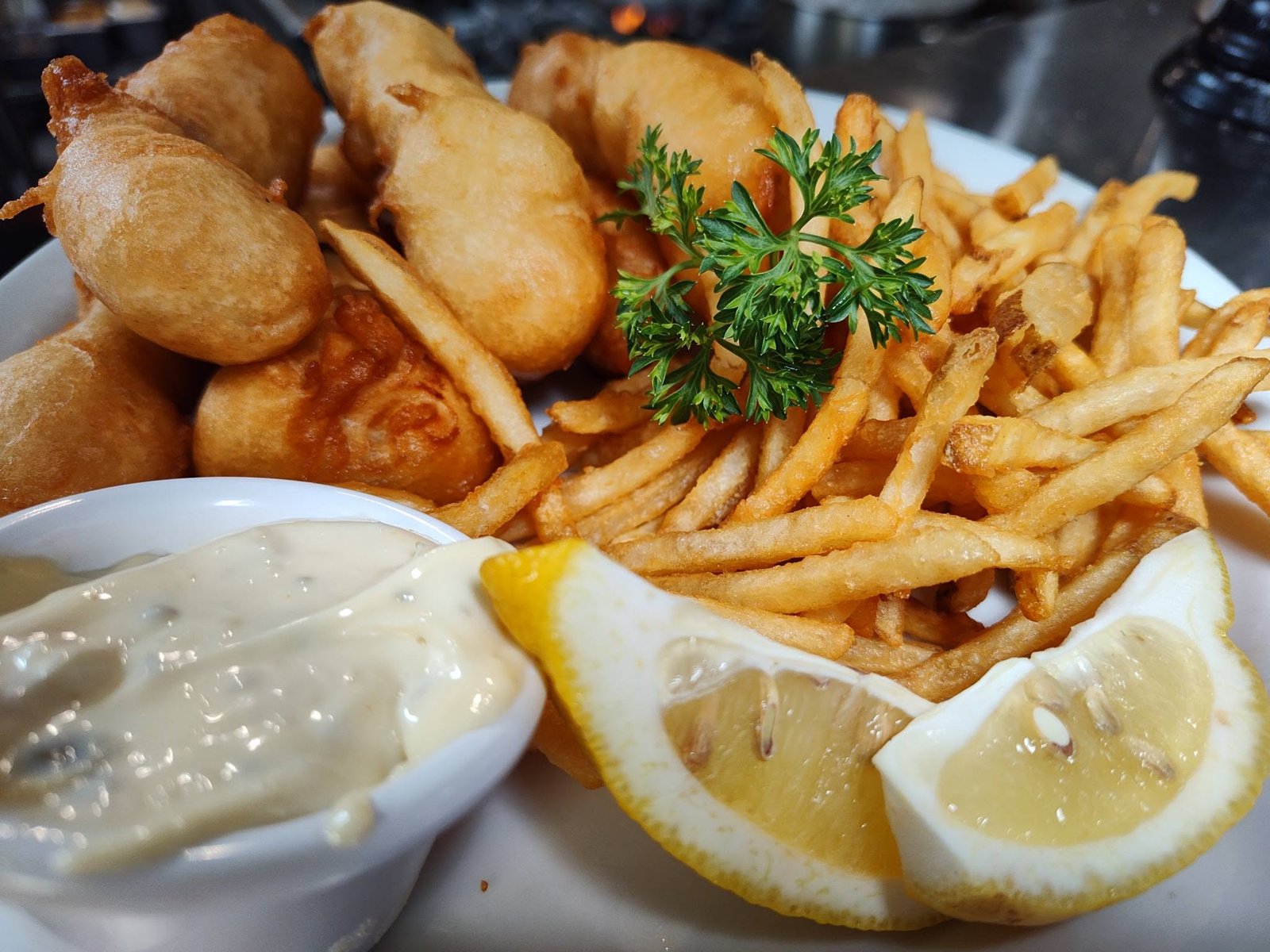 Beer-battered fish and chips with tartar and lemon
