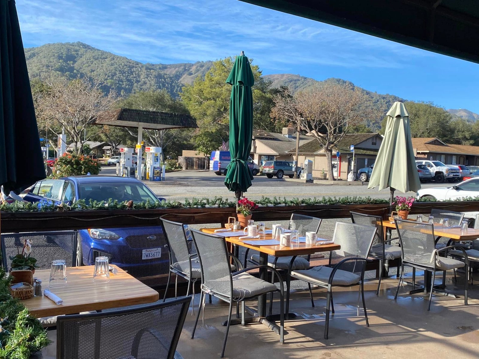 Trailside Café patio with green umbrellas overlooking the Carmel Valley mountains