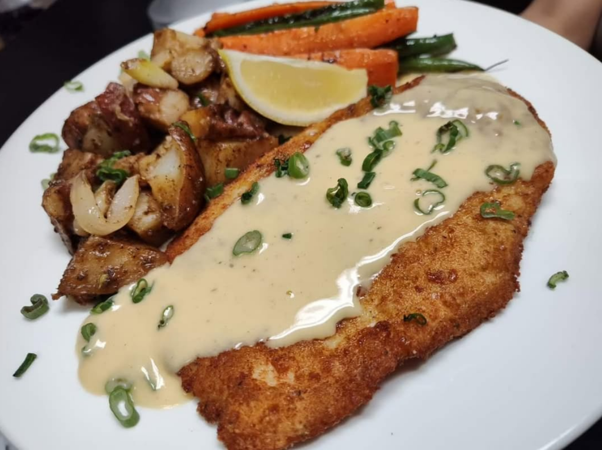 Golden chicken piccata with potatoes and vegetables