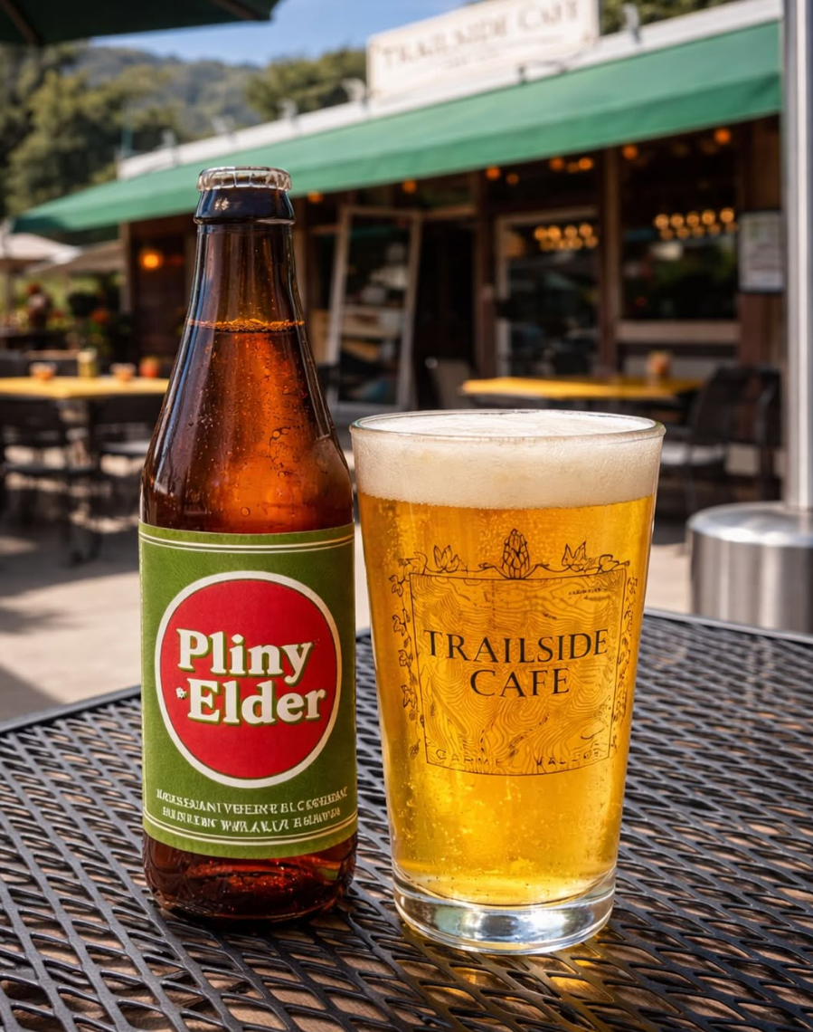 A Pliny the Elder bottle beside a Trailside pint on the patio